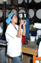workers inspect by hand each bottle of tequila