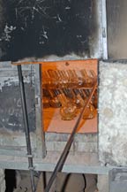 blown glass bottles are placed in an oven to cure