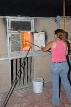 a worker places the molded bottle into an oven to cure