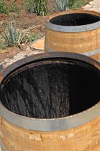 A French white oak barrel, is charred at Tres Mujeres Tequila